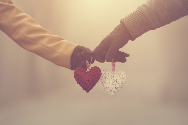 Couple in love holding hearts.