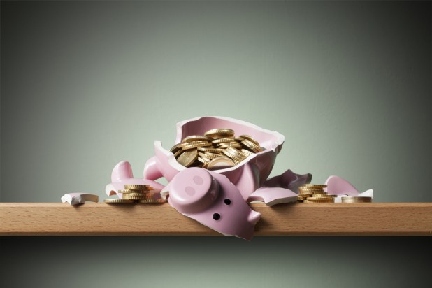 Savings. Broken piggy bank with coins.