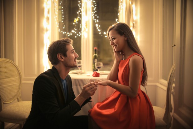 Handsome man proposing a beautiful woman to marry him