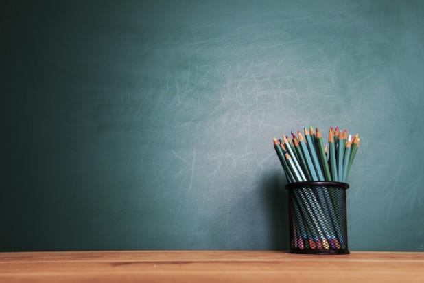 Concept of education or back to school on green background