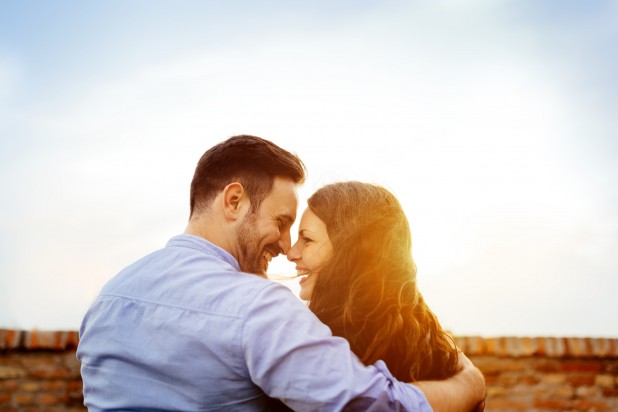 Romantic couple kissing during sunset
